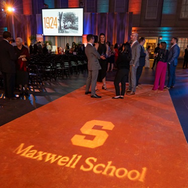 Orange carpet with Maxwell School logo at DC centennial celebration