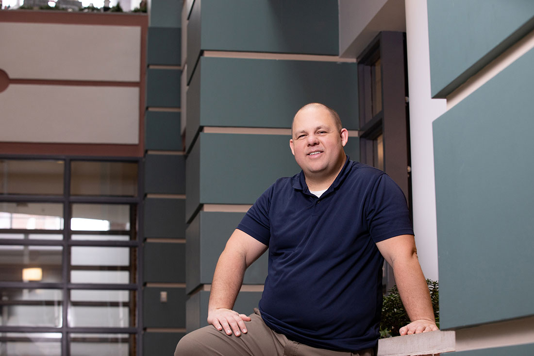 David Larsen standing in atrium of Falk College