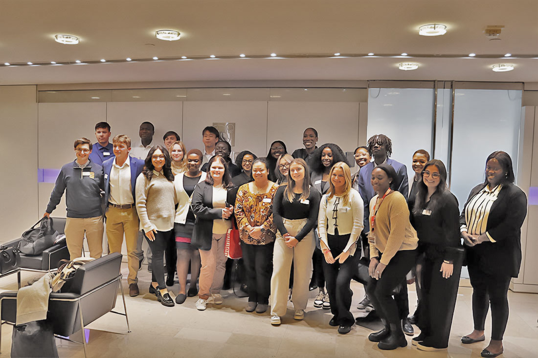 A large group of students are posed in a hall