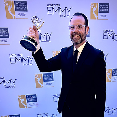 Photo of Jack Herrle holding his Emmy award