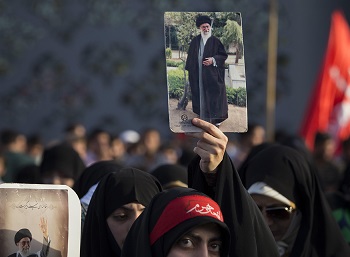 Muslim woman holding photograph Muslim woman holding photograph