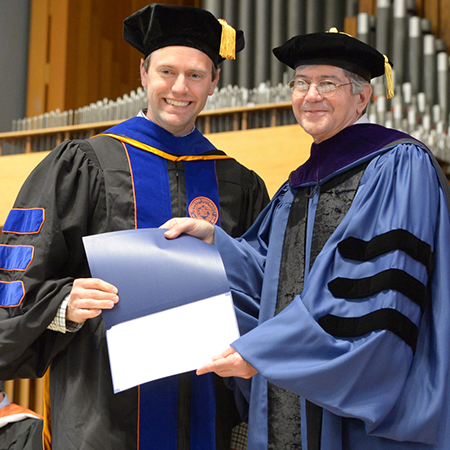 Jim Steinberg presenting a student with a prize at a graduation ceremony Jim Steinberg presenting a student with a prize at a graduation ceremony