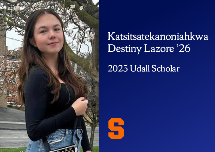 Katsitsatekanoniiahkwa Destiny Lazure '26, 2025 Udall Scholar, standing outdoors with a tree in the background, holding a bag with a floral design.