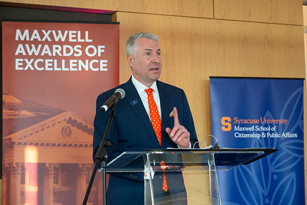 Person speaking at a podium with a