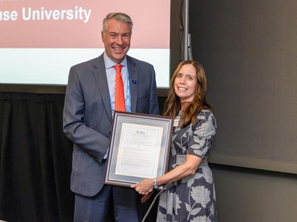 Maxwell Dean David M. Van Slyke receives a proclamation from ICMA's Lynn Phillips honoring the school's commitment to training local government public servants.