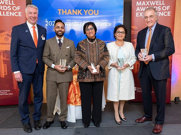 Dean David Van Slyke stands with Awards of Excellence honorees